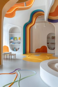 the interior of a children's playroom with rainbow painted walls and flooring