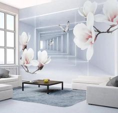 a living room with white furniture and flowers on the wall