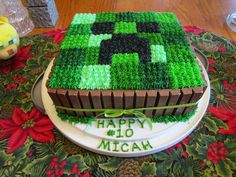 a cake made to look like a minecraft block on top of a table with flowers