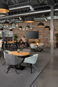 an office with tables, chairs and televisions