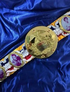 two gold medals are laying on a blue satin surface with an image of queen elizabeth and prince edward