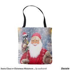 a tote bag with an image of santa holding a teddy bear and a dog