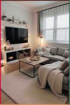 a living room filled with furniture and a flat screen tv mounted on the wall above a fire place