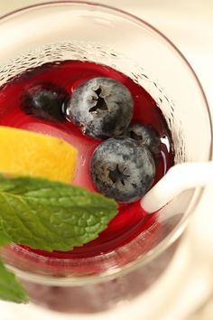 blueberries and lemon in a glass with mint