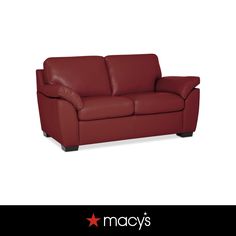 a red leather couch sitting on top of a white floor next to a star logo