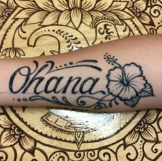 a woman's arm with the word ohana tattooed on it