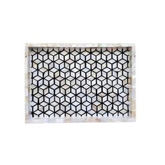 a white and black mosaic tile with geometric designs on the bottom, in an irregular pattern