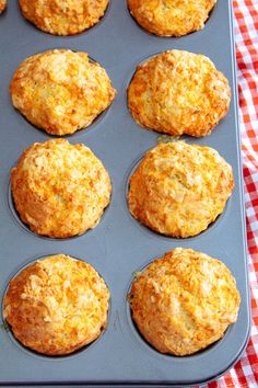 muffins in a baking pan on a red and white checkered tablecloth