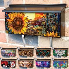 a wall mounted mailbox with sunflowers painted on the front and side panels