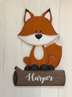 a wooden sign that says harper with a fox on it