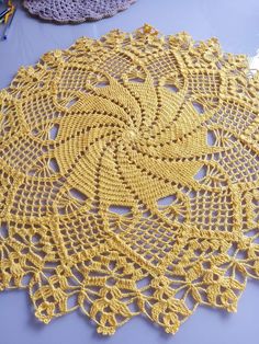 a crocheted doily is laying on a table