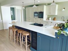 a kitchen with blue cabinets and white counter tops