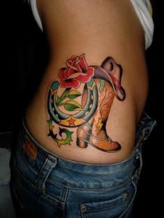 a woman's stomach with a cowboy boot and rose tattoo on the side of her belly