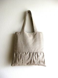 a gray bag hanging on the wall