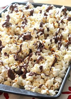 a tray filled with chocolate covered popcorn on top of a table