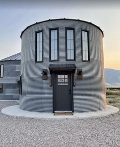 a large round building with two doors and windows