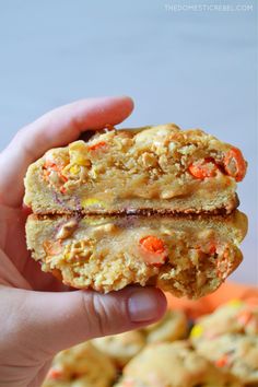 a person holding up a cookie in their hand