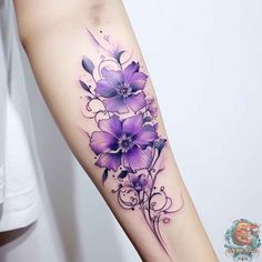 a woman's arm with purple flowers on it