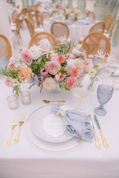 the table is set with flowers and silverware for an elegant wedding breakfast or reception