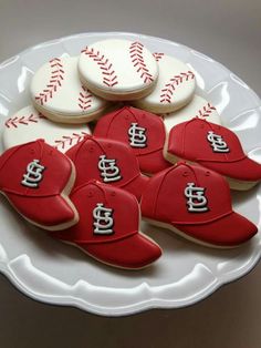 cookies decorated to look like baseballs with the team's logo on them are sitting on a platter