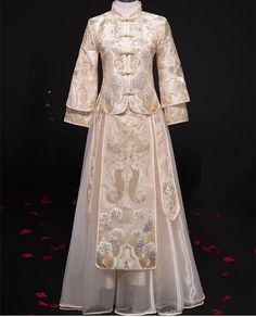 Looking a traditional Chinese bridal gown. This beautiful 2-piece Qun Kwa set is embroidered with gold, silver and white threads. The intricate flower and cloud embroideries are decorated throughout the jacket and skirt. The Tulle skirt give the traditional outfit a modern touch. It's a perfect option for your traditional Chinese wedding, tea ceremony Please note: Asian size run small , please refer to the size guide picture before placing the order. This Qun Kwa Dress for Bride size available f Fitted Wedding Dress For Traditional Ceremonies, Fitted Wedding Dress For Traditional Ceremonies And Festive Season, Festive Fitted Wedding Dress For Traditional Ceremonies, Fitted Wedding Dress For Festive Season, Traditional Long Sleeve Gown With Pearl Embroidery, Elegant Wedding Dress For Traditional Ceremonies, Intricately Embroidered Fitted Wedding Dress For Traditional Ceremonies, Fitted Wedding Dress With Intricate Embroidery For Traditional Ceremonies, Spring Wedding Gold Gown