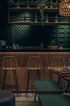 the interior of a restaurant with bar stools and wooden tables in front of it