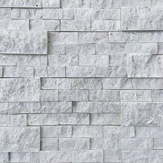 a white brick wall that has been made out of stone blocks and is being used as a background