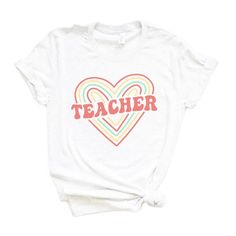 Looking for a cute versatile top to wear this summer? Make sure to grab one of our Colorful Heart Teacher tees! This soft and comfortable graphic tee is the perfect top for any outfit. It can be paired with biker shorts, jeans, or even a simple skirt/dress! This tee is true-to-size, so be sure to order your regular t-shirt size! If you are looking for a more oversized look, make sure to size up! Relaxed Fit Heart Print T-shirt For Summer, Summer Cotton T-shirt With Heart Print, Trendy Heart Graphic T-shirt For Summer, Casual Heart Print T-shirt For Summer, Summer Graphic Tee With Heart Print, Summer Heart Print Short Sleeve T-shirt, Trendy Rainbow Print T-shirt For Summer, Trendy Cotton T-shirt With Heart Print, Trendy Relaxed Fit T-shirt With Heart Print