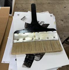 a brush sitting on top of some white papers