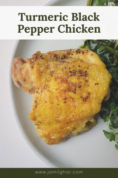 a white plate topped with chicken next to a green leafy salad and text overlay reads tumericic black pepper chicken