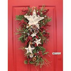 a christmas wreath hanging on a red door