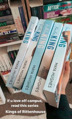 a person holding up several books in front of a book shelf with the title if u love off campus, read this series kings of rittenhouse