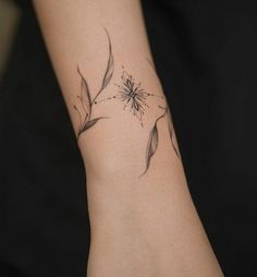 a woman's arm with a flower tattoo on it