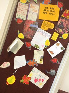 the door is decorated with fall leaves and greetings for someone's special day