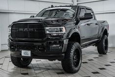 a large black truck parked in a garage