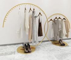 there are two circular mirrors with clothes hanging on the rack and one is holding several pairs of shoes