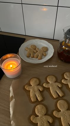 some cookies are sitting on a table next to a lit candle