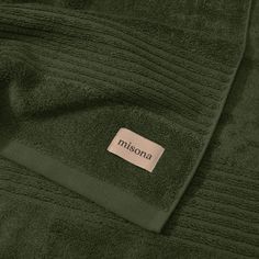 a green towel with the word misona on it and a tag that says misoma