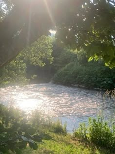 the sun shines brightly over a river