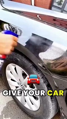 a person is cleaning the side of a car