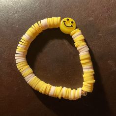 a bracelet made out of toothpicks with a smiley face on it