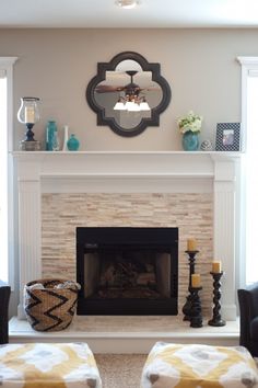 a living room with two couches and a fire place in the middle of it