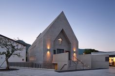 a church with a steeple and lights on it