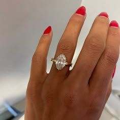 a woman's hand with a diamond ring on it