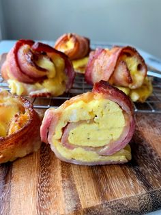 bacon wrapped in cheese on top of a wooden cutting board