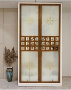 an image of a glass door with decorative designs on the front and side panels that are open