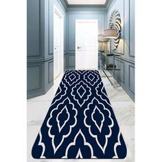 a blue and white rug in the middle of a hallway