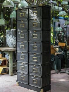 a tall black filing cabinet with lots of drawers