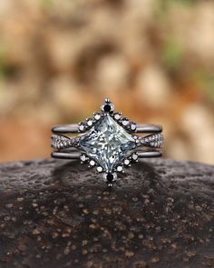 a diamond ring sitting on top of a rock