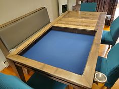 a wooden table with blue chairs around it